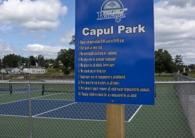 Baraga Community Capul Park sign with rules next to the pickleball court